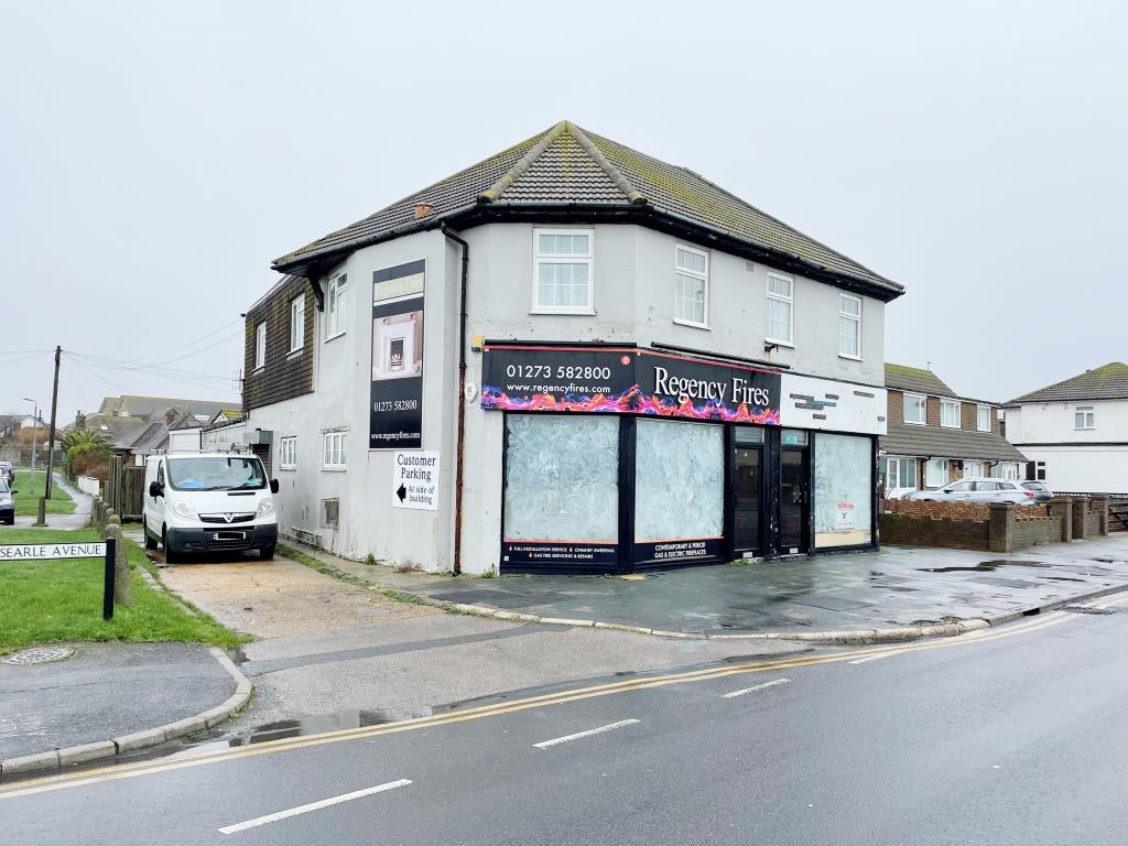 Lot: 85 - TWO FREEHOLD SHOPS PLUS WORKSHOP AND TWO FLATS ABOVE - View of corner property from main road